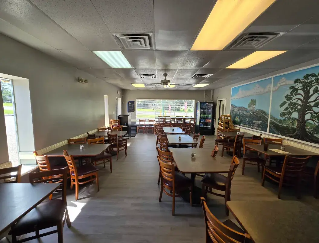 The dining room at Chickpeas, with hand-painted murals along one wall